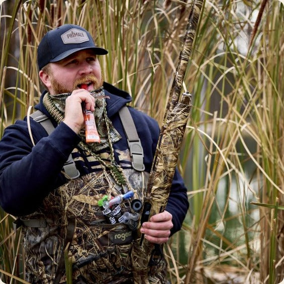Hunter eating a brisket stick in the blind